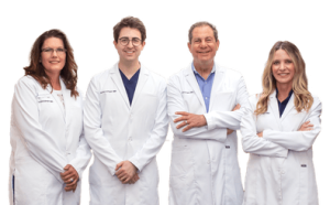 Drs. Joel and Daniel Schlessinger standing with their Physician Assistants