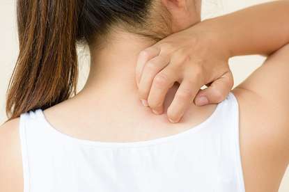 Woman Scratching the Back of Her Neck